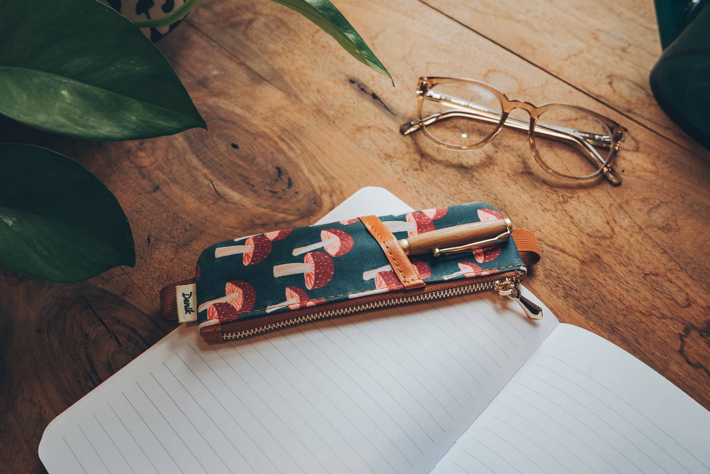 mushroom notebook pouch, vegan leather journal pouch, embroidered pencil pouch, Denik mushroom design, navy pen holder, faux suede notebook strap, sketchbook pen pouch, artist-driven notebook accessory, school-funding stationery