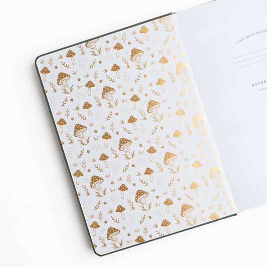 Archer and Olive Mushrooms journal open to illustrated mushroom endpaper and white pages