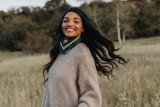 Endless Bloom bandana by Bandits Bandanas featuring four stylized orange foxes arranged in a circular floral pattern on a deep teal background with yellow flowers