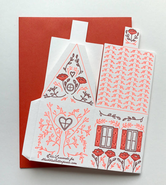 we’re in this together card, 3D house card, letterpress house card, neon red letterpress, foldable house card, buildable paper house, die-cut letterpress card, supportive greeting card, encouragement card, friendship card, solidarity gift, cotton paper card, miniature house card, displayable card, artisan letterpress stationery, Blackbird Letterpress card, Rogue & Rye letterpress collection, A2 letterpress greeting card, paper craft house card, illustrated by Élise Lassonde