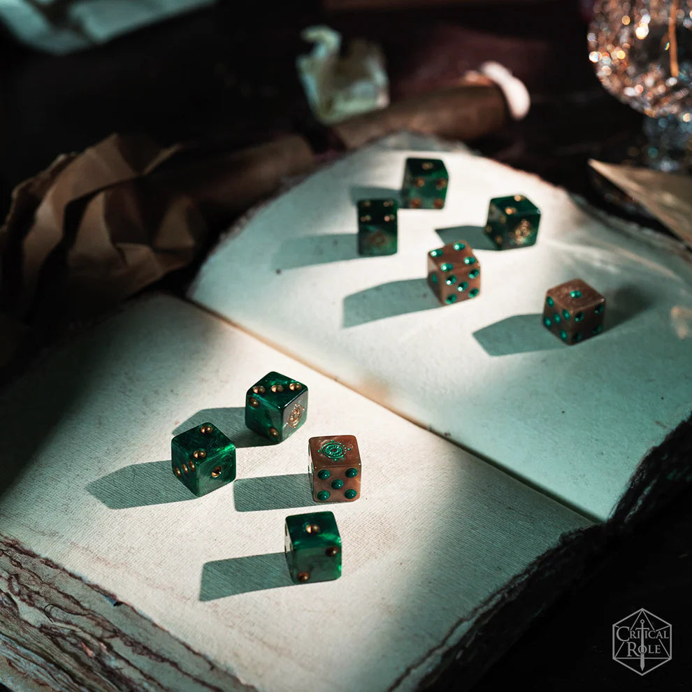 Candela Obscura dice, Critical Role dice set, Candela Obscura RPG accessories, paranormal RPG dice, Fairelands dice, pearlescent green d6 dice, gold gilded dice, custom six-sided dice, resin D6 set, Aaron Monroy logo dice, Critical Role Candela merch, horror fantasy RPG dice, gilded roleplaying dice, Candela Obscura tabletop gear, green and gold dice set