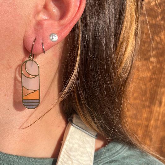 horizon earrings, stained glass earrings, resin brass earrings, landscape earrings, handmade dangle earrings, modern art jewelry, lightweight artisan earrings, boho nature earrings, scenic resin earrings, everyday statement earrings, brass and resin jewelry, Rogue & Rye accessories, unique handmade gifts, nature-inspired fashion, colorful dangle earrings, artistic resin earrings, handcrafted earrings for women, gift for nature lovers, soft pastel earrings, modern nature jewelry