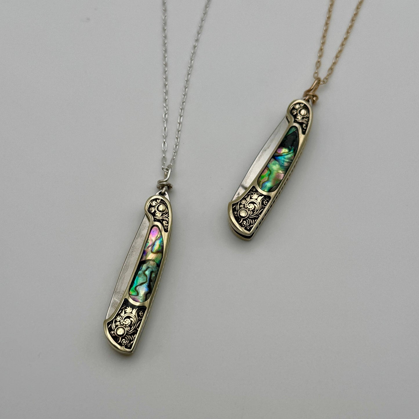 lennox necklace knife, mini knife necklace gold, abalone pocket knife jewelry, stealthy knife pendant, gold filled knife necklace, functional knife jewelry, filigree knife necklace, vintage inspired utility necklace, pocket knife necklace for women, adventurer jewelry, abalone shell pendant knife, necklace with hidden blade, fashionable self defense necklace, secret blade necklace, gold mini knife pendant