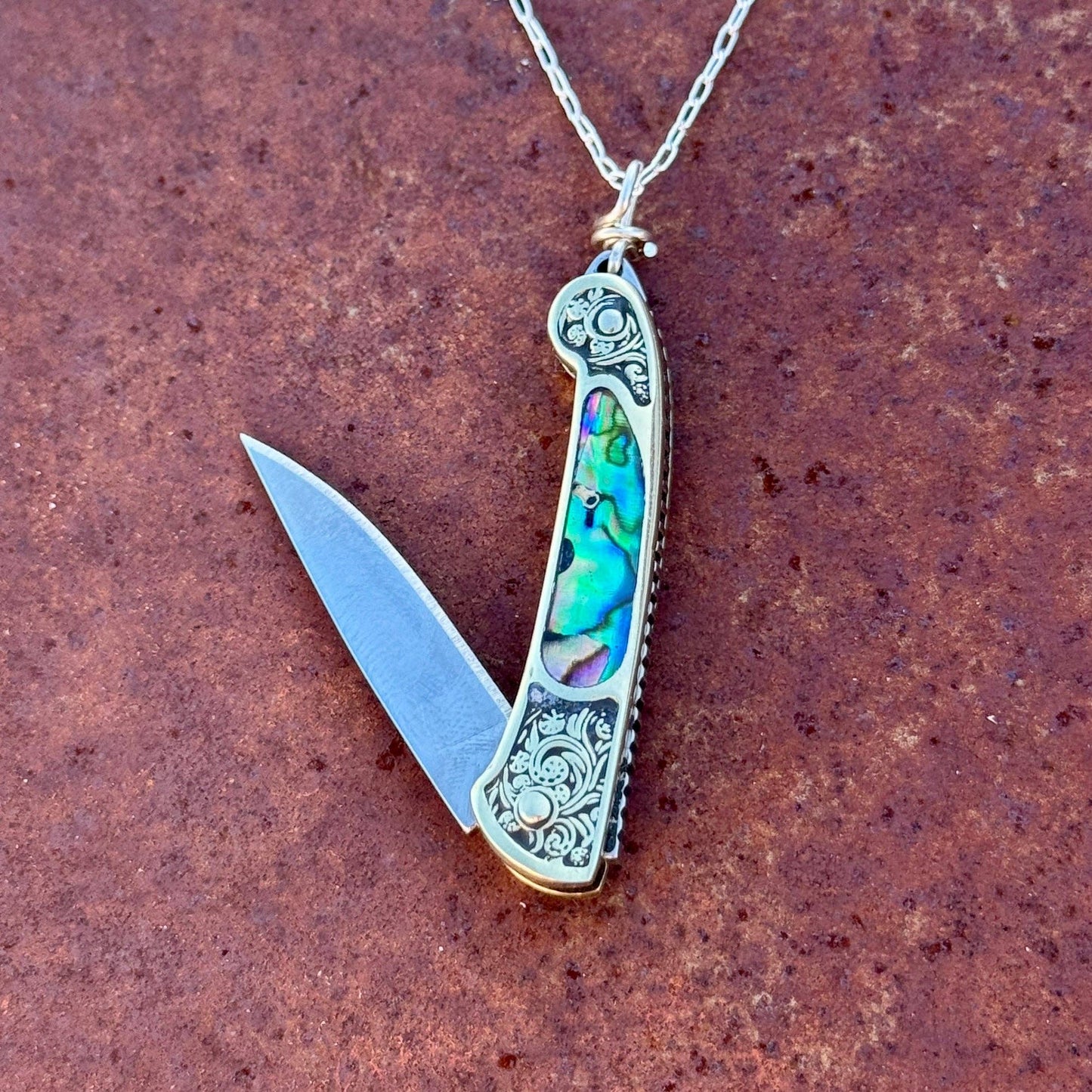 lennox necklace knife, mini knife necklace gold, abalone pocket knife jewelry, stealthy knife pendant, gold filled knife necklace, functional knife jewelry, filigree knife necklace, vintage inspired utility necklace, pocket knife necklace for women, adventurer jewelry, abalone shell pendant knife, necklace with hidden blade, fashionable self defense necklace, secret blade necklace, gold mini knife pendant