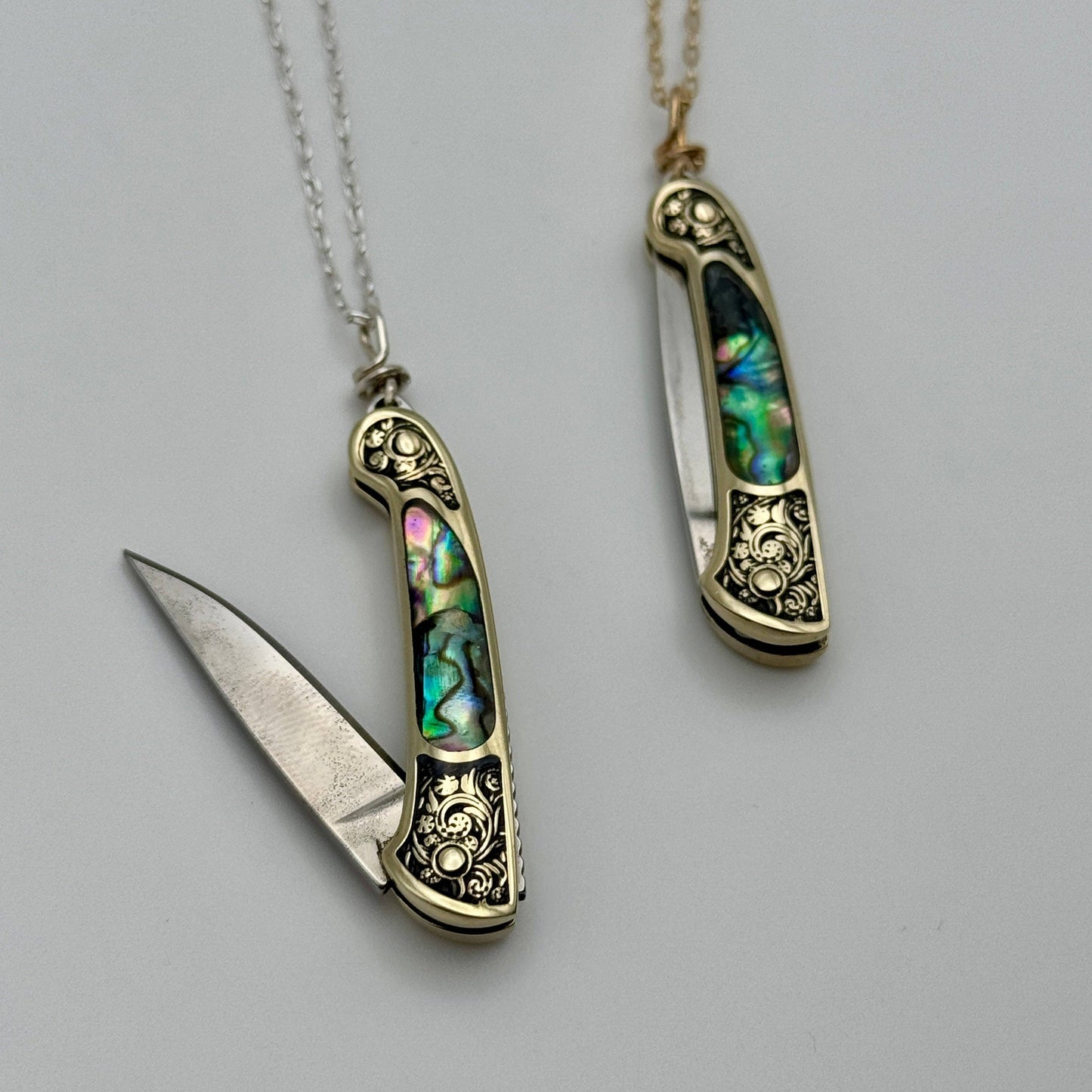 lennox necklace knife, mini knife necklace gold, abalone pocket knife jewelry, stealthy knife pendant, gold filled knife necklace, functional knife jewelry, filigree knife necklace, vintage inspired utility necklace, pocket knife necklace for women, adventurer jewelry, abalone shell pendant knife, necklace with hidden blade, fashionable self defense necklace, secret blade necklace, gold mini knife pendant