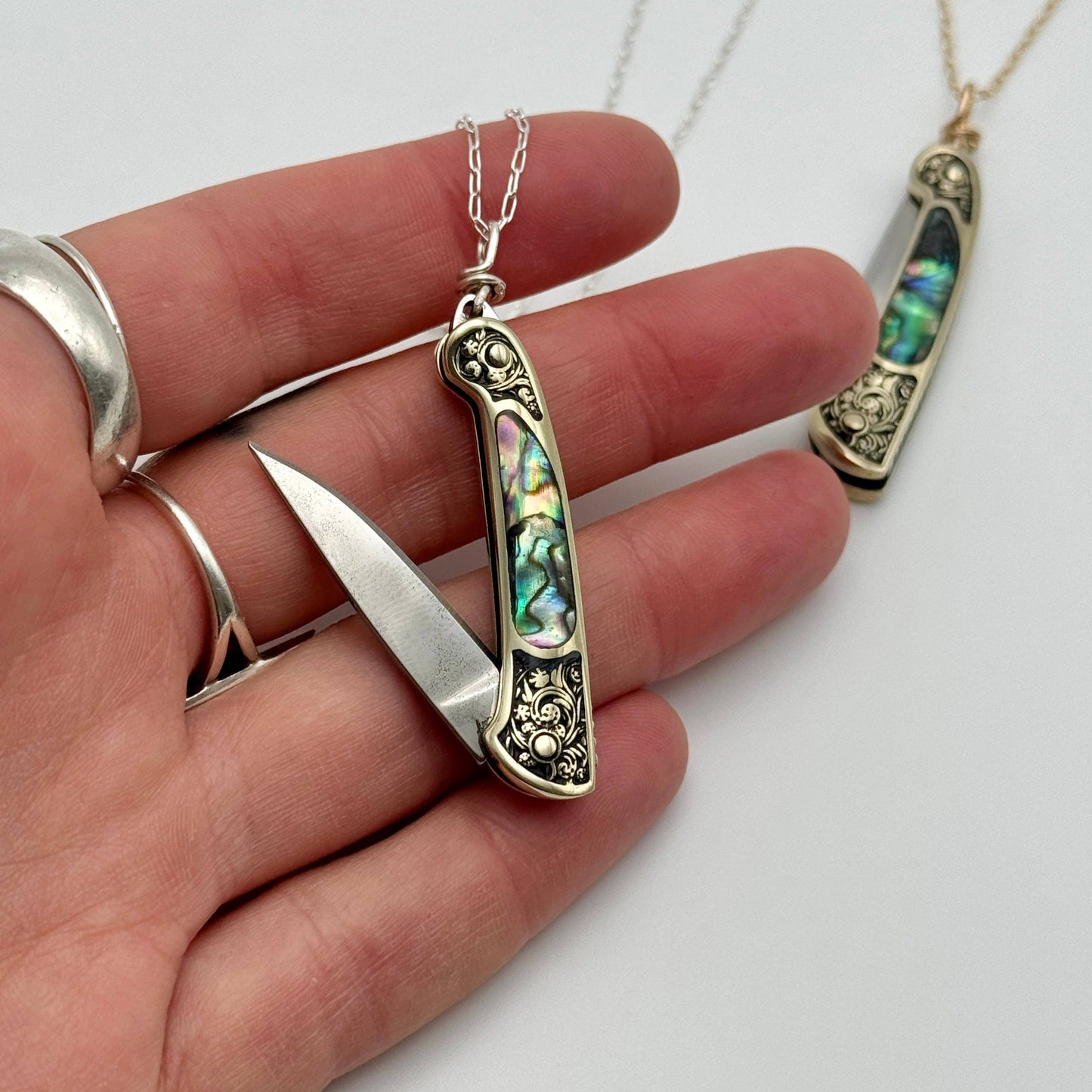 lennox necklace knife, mini knife necklace gold, abalone pocket knife jewelry, stealthy knife pendant, gold filled knife necklace, functional knife jewelry, filigree knife necklace, vintage inspired utility necklace, pocket knife necklace for women, adventurer jewelry, abalone shell pendant knife, necklace with hidden blade, fashionable self defense necklace, secret blade necklace, gold mini knife pendant