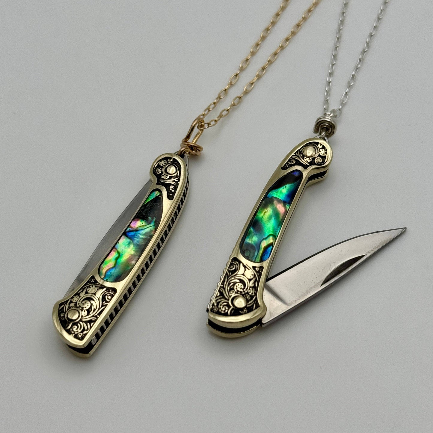 lennox necklace knife, mini knife necklace gold, abalone pocket knife jewelry, stealthy knife pendant, gold filled knife necklace, functional knife jewelry, filigree knife necklace, vintage inspired utility necklace, pocket knife necklace for women, adventurer jewelry, abalone shell pendant knife, necklace with hidden blade, fashionable self defense necklace, secret blade necklace, gold mini knife pendant