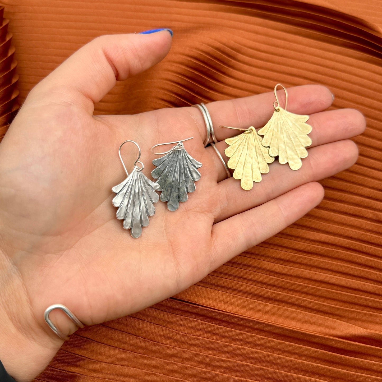 The Fluff Hardware Flight Earrings (Mini) are lightweight, vintage-inspired statement earrings with softly textured pendants in your choice of gold or silver. Finished with hypoallergenic sterling silver or 14k gold filled ear wires, these small-batch earrings are easy to dress up or down—an effortless everyday accessory and a thoughtful gift for anyone who loves nature-inspired jewelry with a modern, wearable shape.