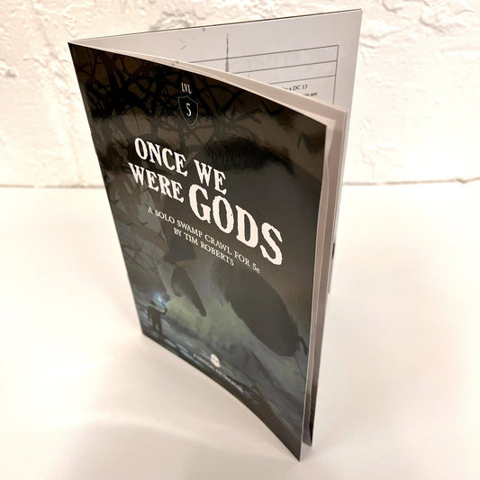 once we were gods solo RPG, 5e solo adventure set, mythic solo TTRPG kit, solo RPG with artifacts, swamp-themed dice RPG, immersive solo 5e game, resin artifact RPG set, deluxe solo roleplaying game, Tim Roberts solo RPG, storytelling grid-based solo game