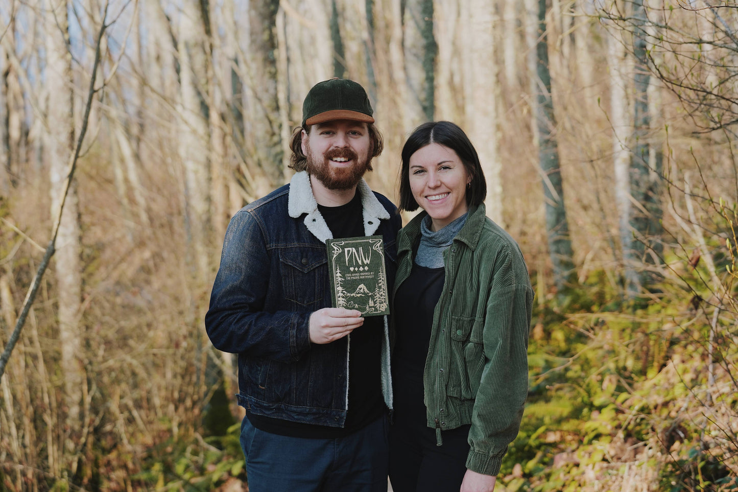 pnw card games book, pacific northwest inspired games, megan wyreweden art, thomas cardwell game designer, nature themed card games, foraging card games, orca salmon mushroom games, coastal forest games, pacific northwest game night, illustrated card game book, camping games with deck of cards, solo and group card games, pnw camping activities, original card games book, pacific northwest gifts, travel