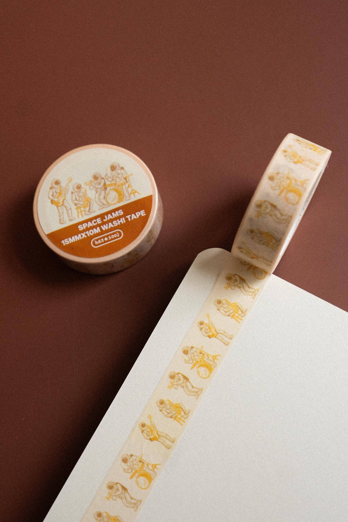 Roll of Space Jams washi tape beside a strip of musical astronaut illustrations