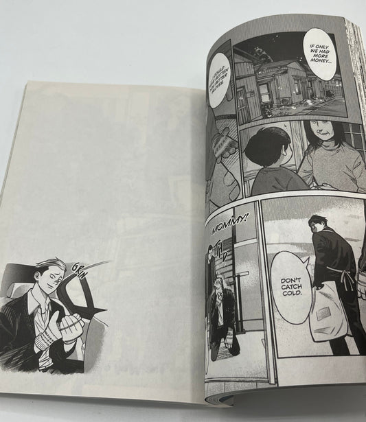 Interior manga pages from The Way of the Househusband Volume 1 featuring Tatsu in a black-and-white slice-of-life scene with expressive artwork and dialogue panels.