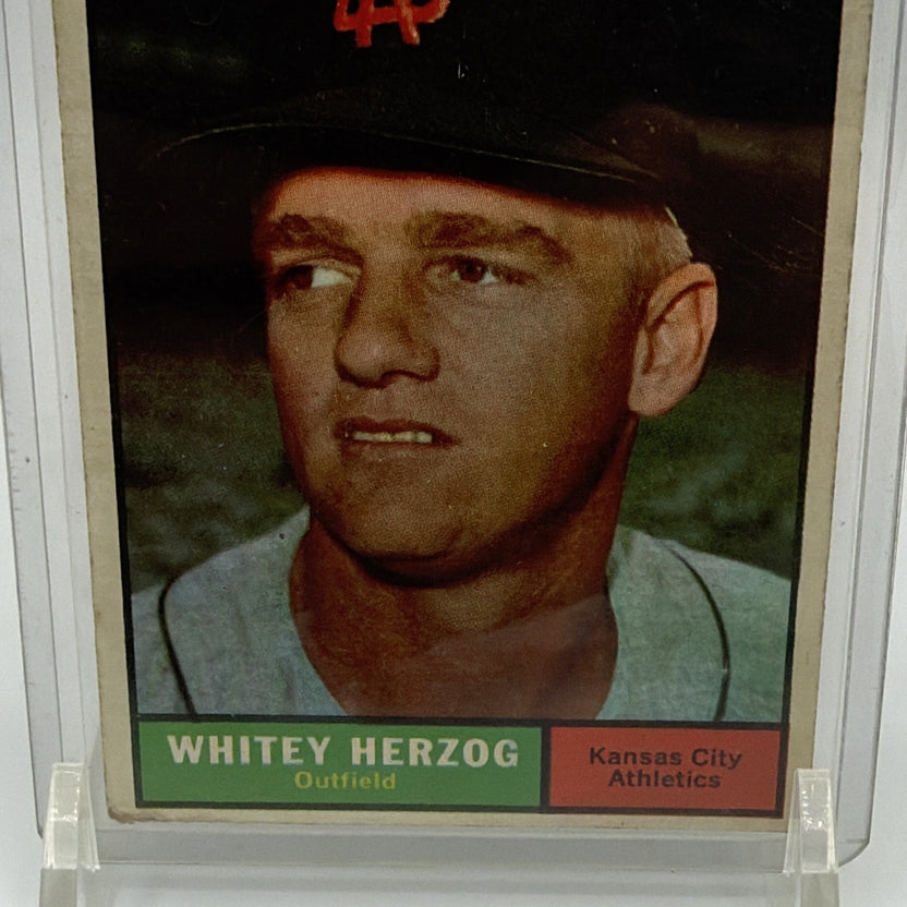 Detail of 1961 Topps Whitey Herzog #106 showing his portrait, green nameplate, and red outfielder designation