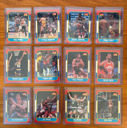 1986 Fleer Basketball cards #109–120 displayed from the complete 1986–87 Fleer Basketball set. Featured players include Isiah Thomas #109, LaSalle Thompson #110, Mychal Thompson #111, Sedale Threatt #112, Wayman Tisdale #113, Andrew Toney #114, Kelly Tripucka #115, Melvin Turpin #116, Kiki Vandeweghe #117, Jay Vincent #118, Bill Walton #119, and Spud Webb #120. Part of the iconic 1986 Fleer Basketball release.