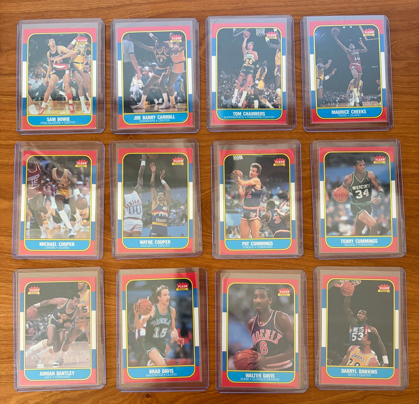 1986 Fleer Basketball cards #13–24 displayed from the complete 1986–87 Fleer Basketball set. Featured players include Sam Bowie #13, Joe Barry Carroll #14, Tom Chambers #15, Maurice Cheeks #16, Michael Cooper #17, Wayne Cooper #18, Pat Cummings #19, Terry Cummings #20, Adrian Dantley #21, Brad Davis #22, Walter Davis #23, and Darryl Dawkins #24. Part of the iconic 1986 Fleer Basketball release.