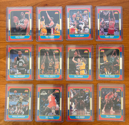 Fronts of 1986 Fleer Basketball cards #37–48 from the complete 1986–87 Fleer Basketball set. Featured players include Artis Gilmore #37, Mike Gminski #38, Ricky Green #39, Sidney Green #40, Dave Greenwood #41, Darrell Griffith #42, Bill Hanzlik #43, Derek Harper #44, Gerald Henderson #45, Roy Hinson #46, Craig Hodges #47, and Phil Hubbard #48. This section includes notable NBA veterans Artis Gilmore and Derek Harper alongside players from the Spurs, Jazz, Bulls, Mavericks, Sonics, 76ers, Bucks, and Cavalier