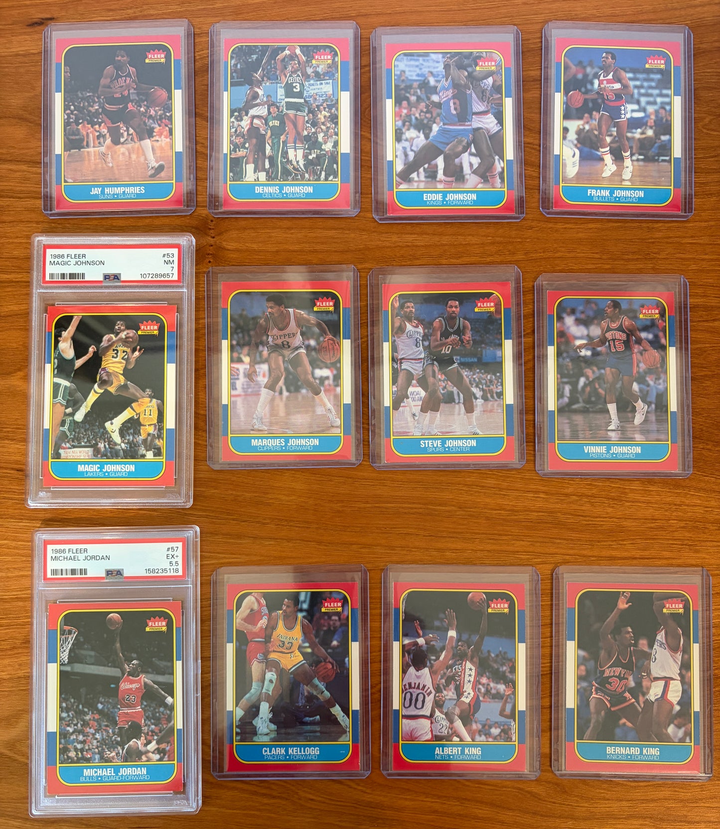 1986 Fleer Basketball cards #49–60 featuring Magic Johnson #53 PSA 7 and Michael Jordan rookie card #57 PSA 5.5, displayed with surrounding cards from the complete 1986–87 Fleer Basketball set.