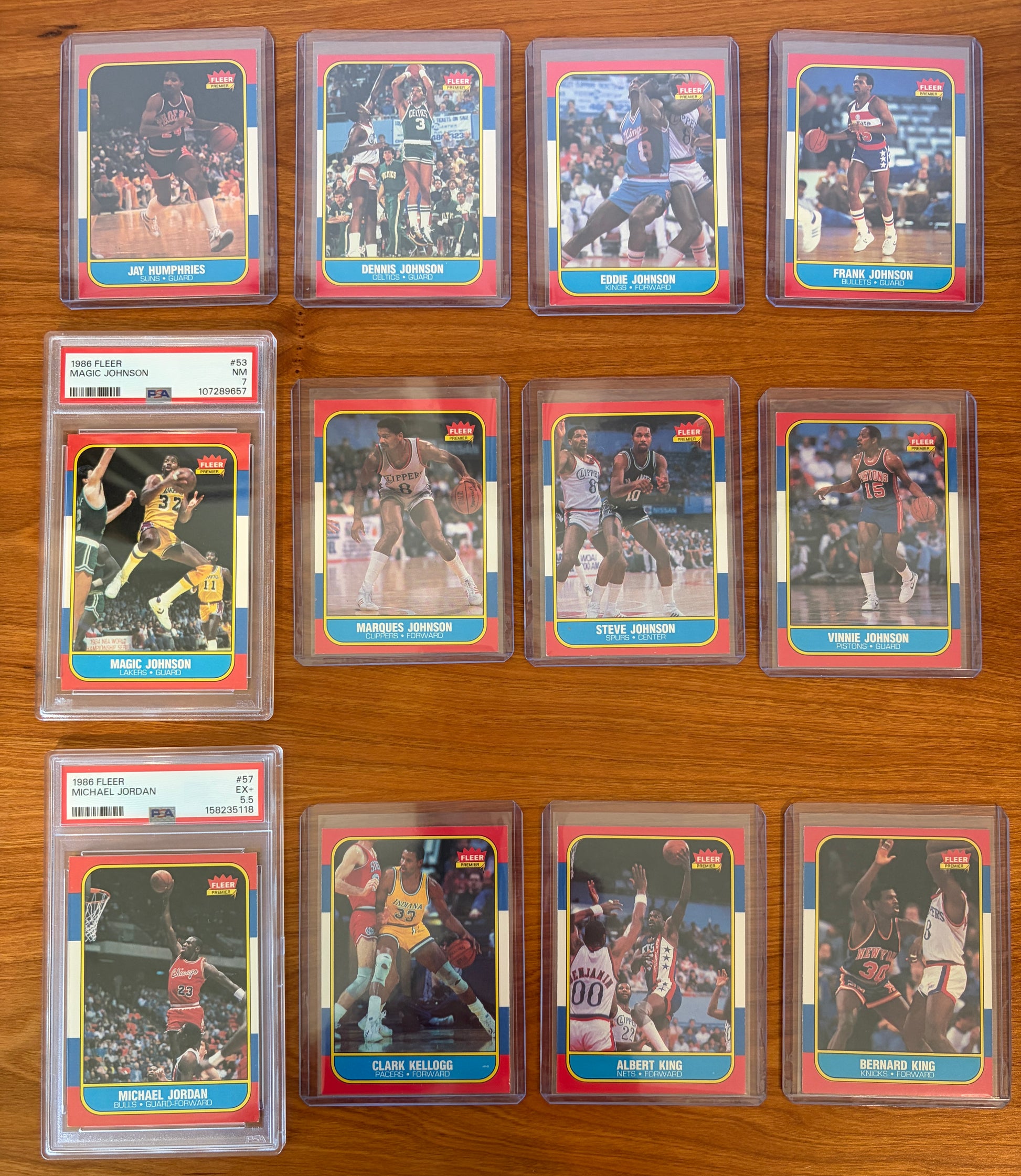 1986 Fleer Basketball cards #49–60 featuring Magic Johnson #53 PSA 7 and Michael Jordan rookie card #57 PSA 5.5, displayed with surrounding cards from the complete 1986–87 Fleer Basketball set.