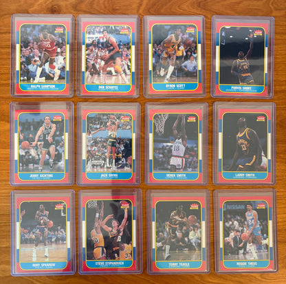 Fronts of 1986 Fleer Basketball cards #97–108 from the complete 1986–87 Fleer Basketball set. Featured players include Ralph Sampson #97, Dan Schayes #98, Byron Scott #99, Purvis Short #100, Jack Sikma #101, Jerry Sichting #102, Derek Smith #103, Larry Smith #104, Rory Sparrow #105, Steve Stipanovich #106, Terry Teagle #107, and Reggie Theus #108. Notable stars Ralph Sampson, Jack Sikma, Byron Scott, Reggie Theus, and Purvis Short highlight this section of the iconic 1986 Fleer Basketball release.