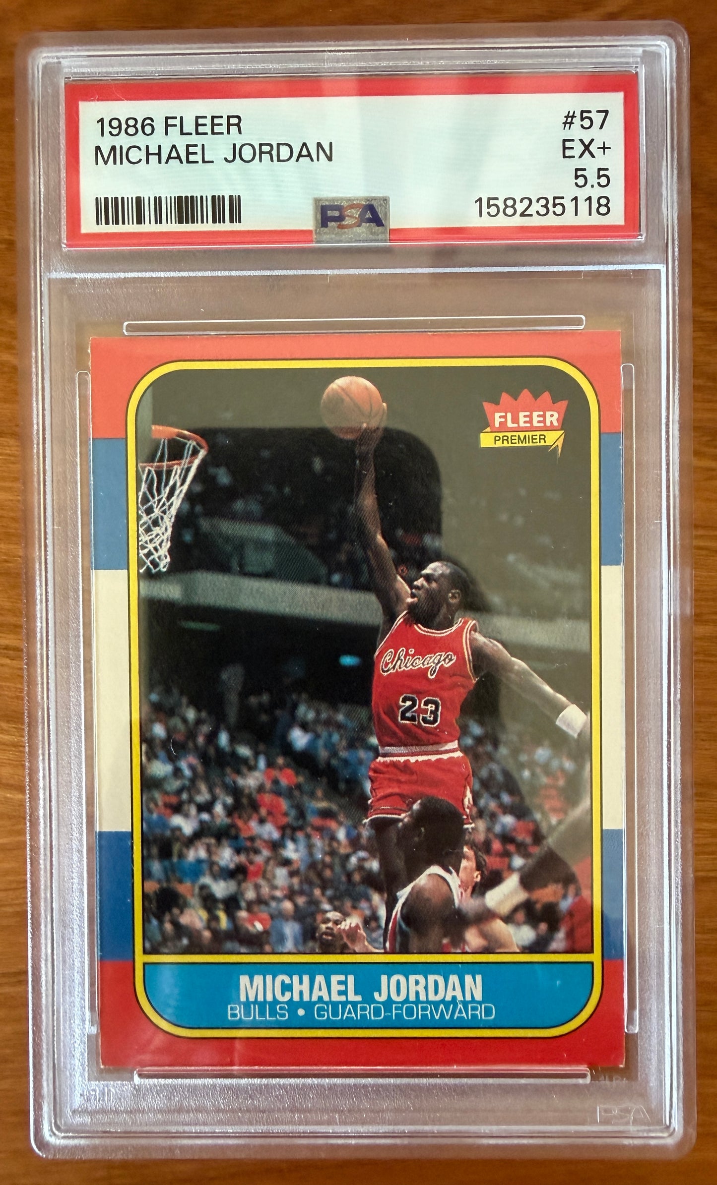 1986 Fleer Michael Jordan rookie card #57 graded PSA 5.5 (EX+). The iconic card features Jordan in a Chicago Bulls uniform soaring toward the basket for a one-handed dunk. Widely regarded as one of the most important basketball rookie cards ever produced, the card is encapsulated in an authenticated PSA holder.