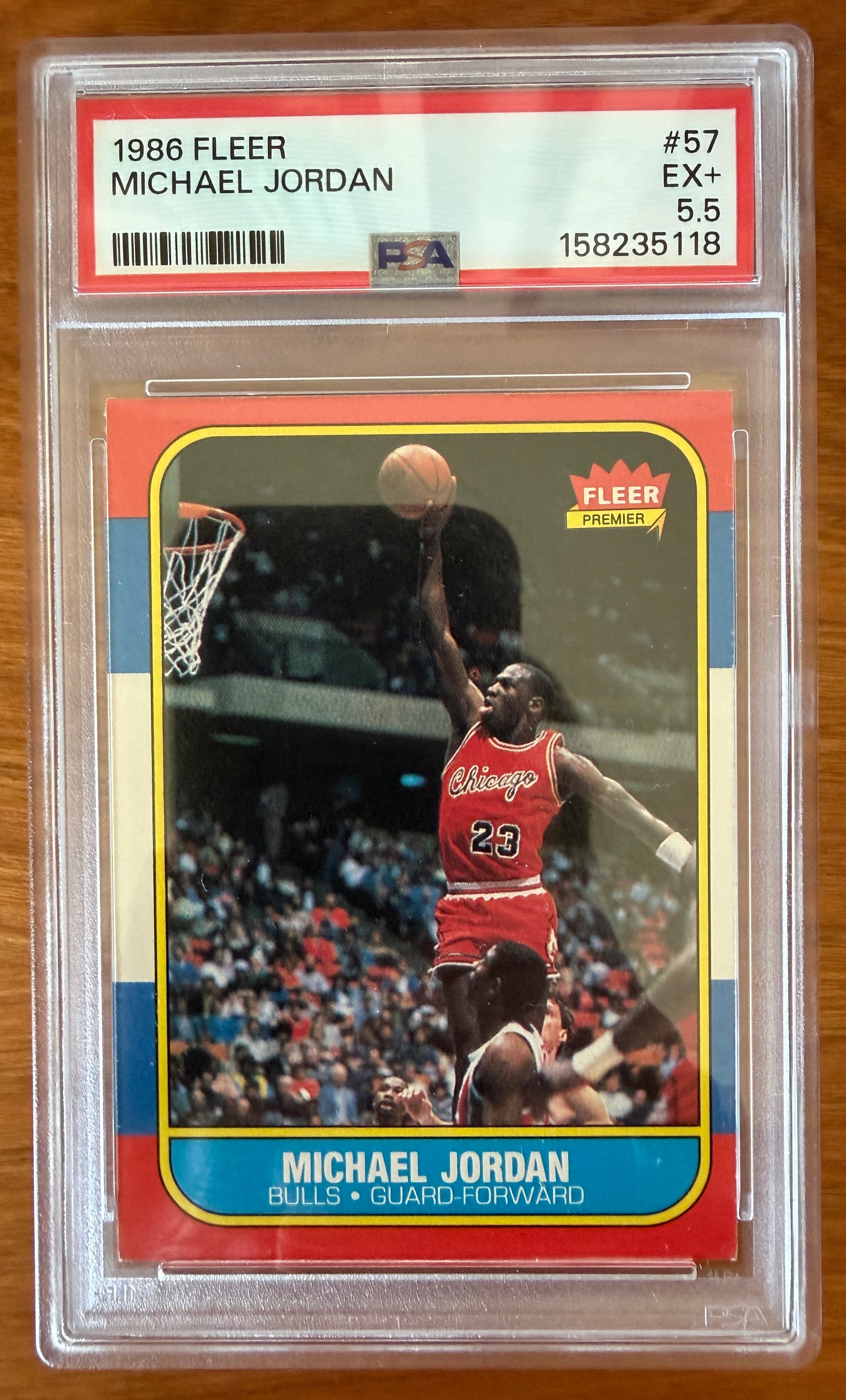 1986 Fleer Michael Jordan rookie card #57 graded PSA 5.5 (EX+). The iconic card features Jordan in a Chicago Bulls uniform soaring toward the basket for a one-handed dunk. Widely regarded as one of the most important basketball rookie cards ever produced, the card is encapsulated in an authenticated PSA holder.