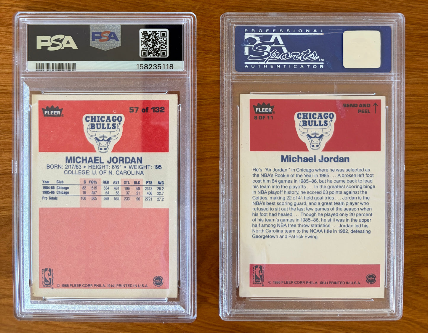 Backs of Michael Jordan's 1986 Fleer rookie card #57 PSA 5.5 and 1986 Fleer sticker #8 PSA 7 displayed side by side. The rookie card back features Jordan's early Chicago Bulls statistics and biographical information, while the sticker back includes a player profile highlighting his Rookie of the Year season and collegiate career at North Carolina. Both are encapsulated in authenticated PSA holders.