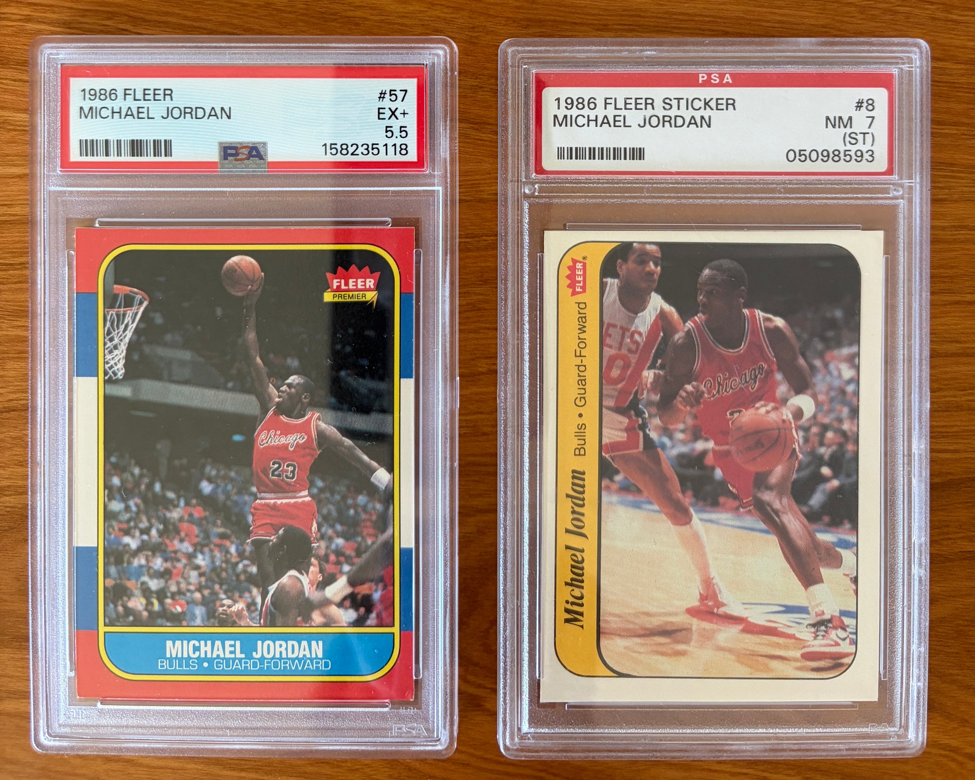 Side-by-side display of Michael Jordan's iconic 1986 Fleer rookie card #57 graded PSA 5.5 and 1986 Fleer sticker #8 graded PSA 7. Both cards feature Jordan in his Chicago Bulls uniform and are encapsulated in authenticated PSA holders. Together, they represent two of the most sought-after pieces from the legendary 1986 Fleer Basketball release.