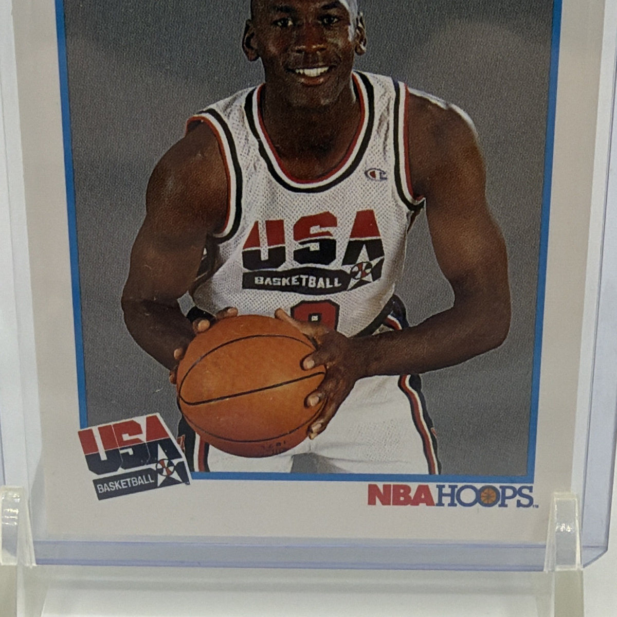 Detail of Michael Jordan holding a basketball in his white USA Basketball jersey