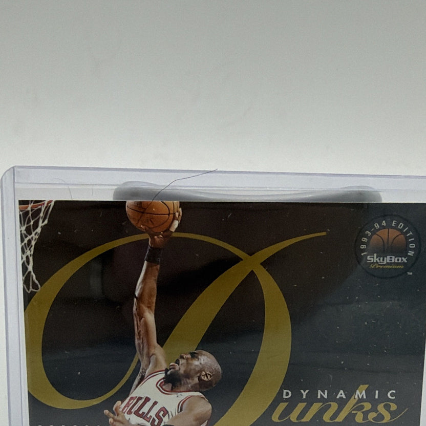Closer view of Michael Jordan Dynamic Dunks D4 card with black background and sweeping gold graphics