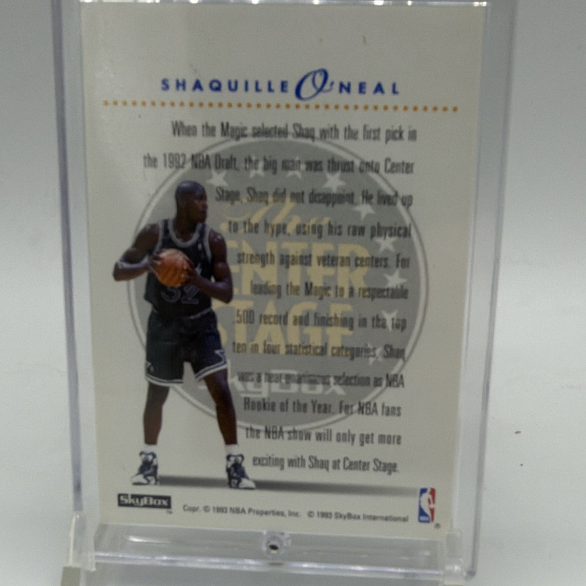Reverse of 1993–94 SkyBox Center Stage Shaquille O'Neal #CS2 with player photograph and biographical text