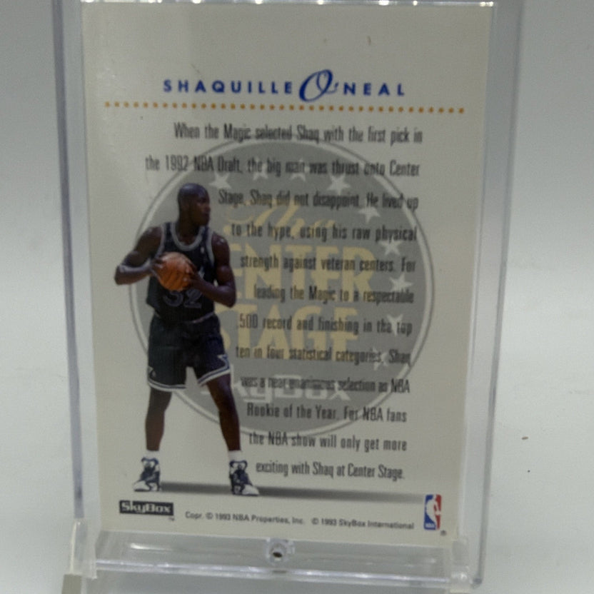 Reverse of 1993–94 SkyBox Center Stage Shaquille O'Neal #CS2 with player photograph and biographical text