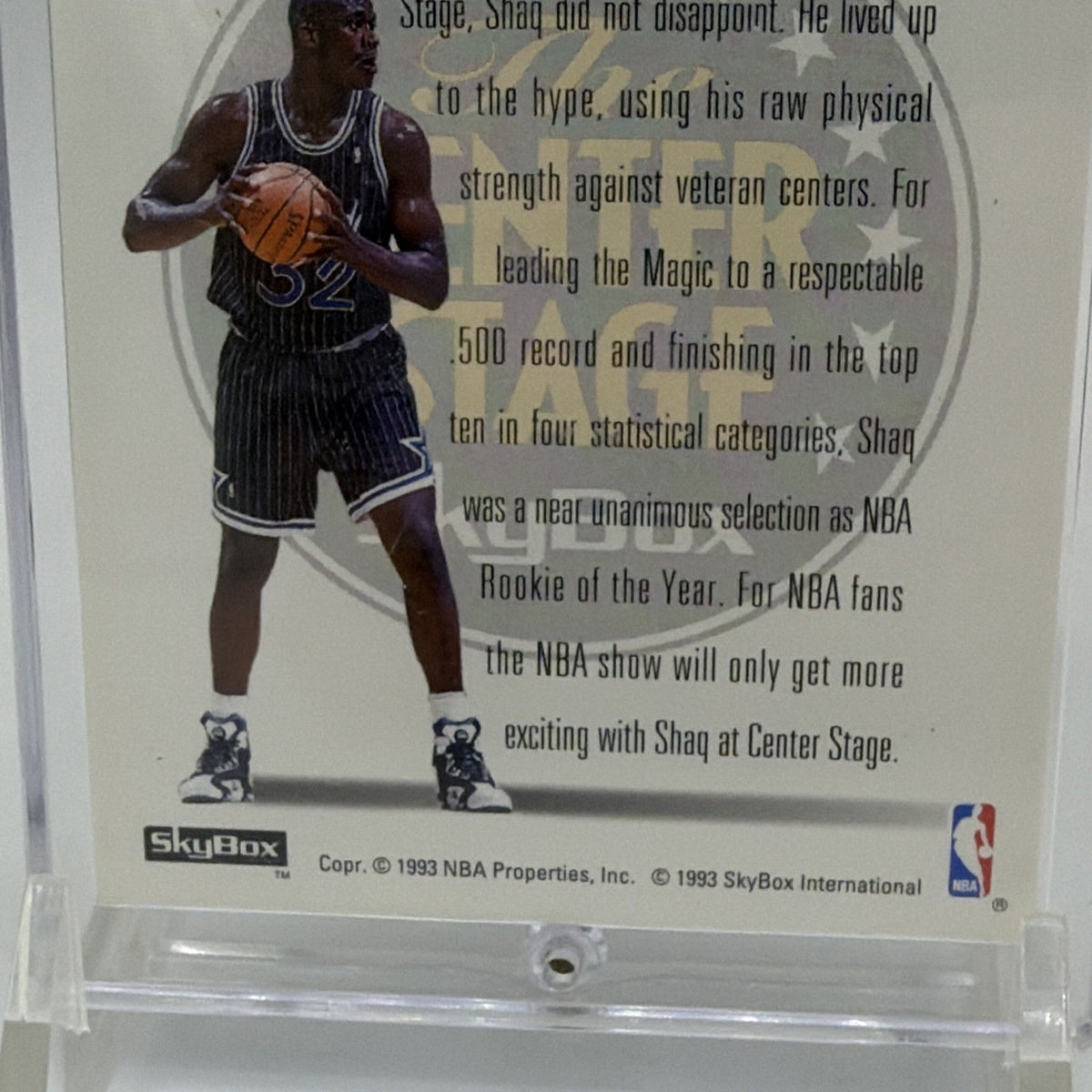 Lower reverse detail of 1993–94 SkyBox Center Stage Shaquille O'Neal #CS2 featuring Shaq in his Orlando Magic uniform