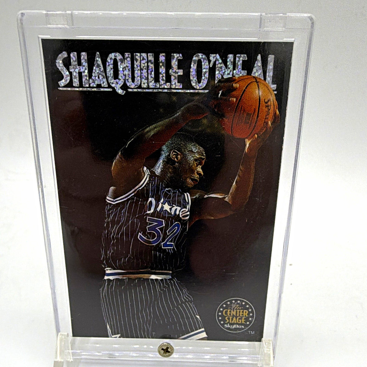Front of 1993–94 SkyBox Center Stage Shaquille O'Neal #CS2 basketball insert featuring Shaq in an Orlando Magic pinstriped uniform