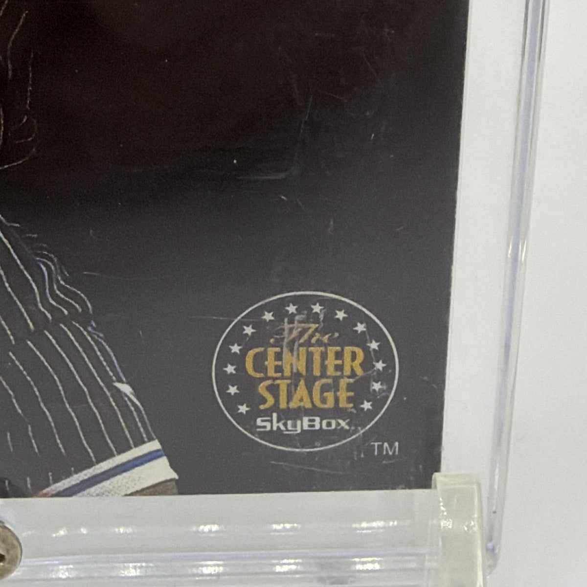 Close-up of gold Center Stage emblem on 1993–94 SkyBox Shaquille O'Neal basketball insert card