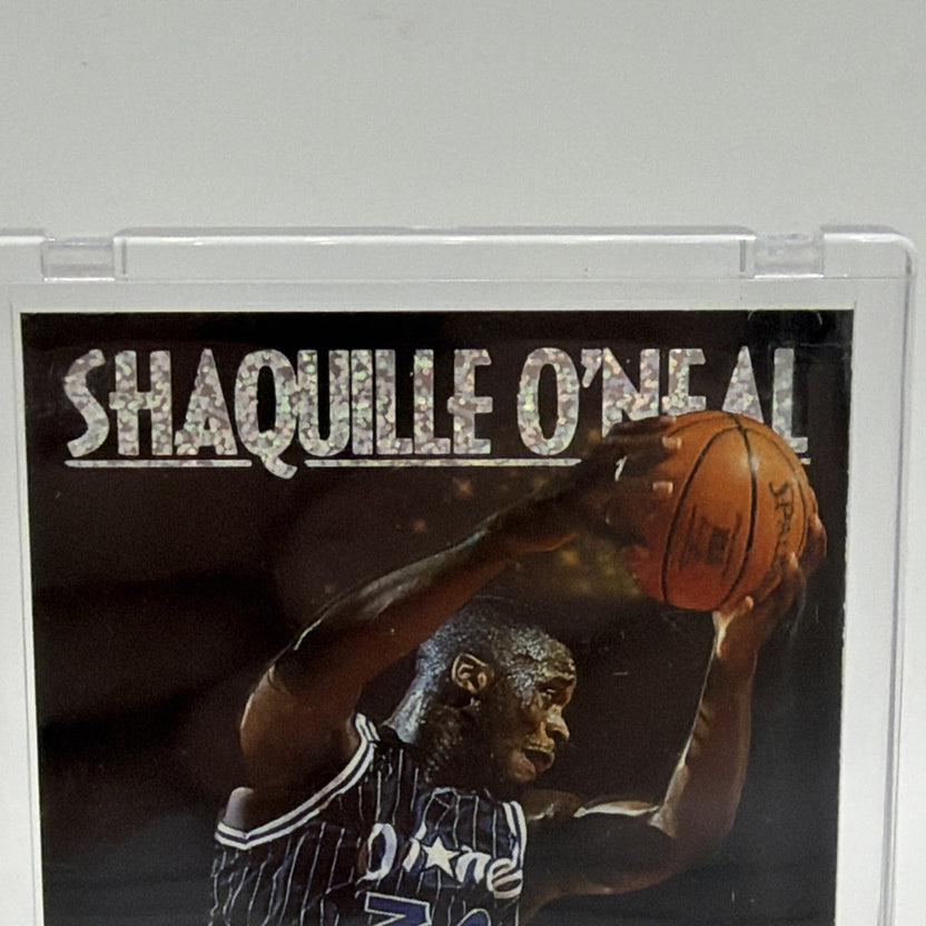 Close-up of Shaquille O'Neal raising a basketball toward the hoop on his 1993–94 SkyBox Center Stage insert
