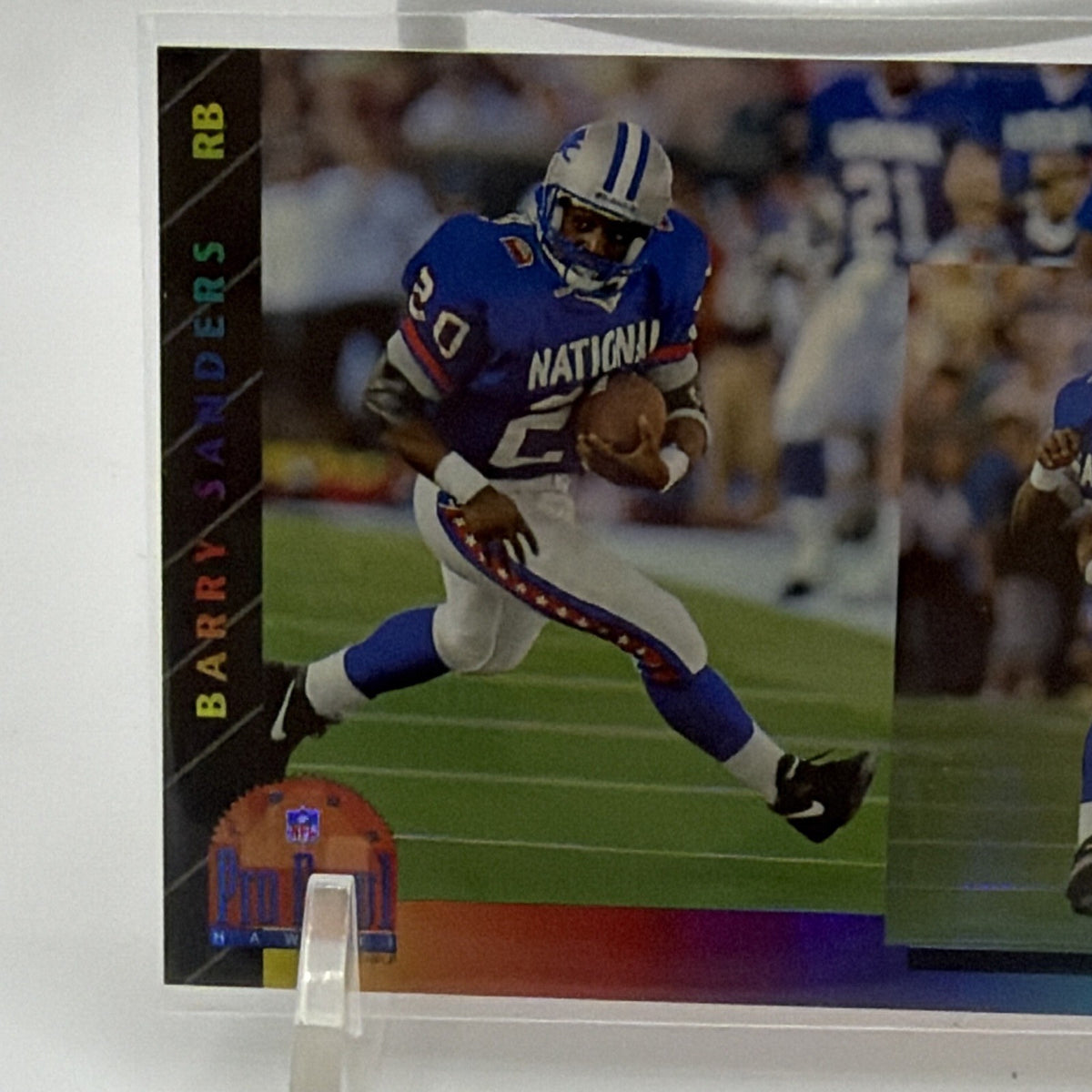 Close-up of Barry Sanders running with the football in his blue NFC Pro Bowl uniform
