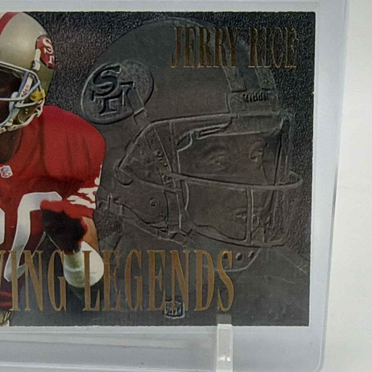 Detail of metallic-style football helmet artwork and gold Living Legends lettering