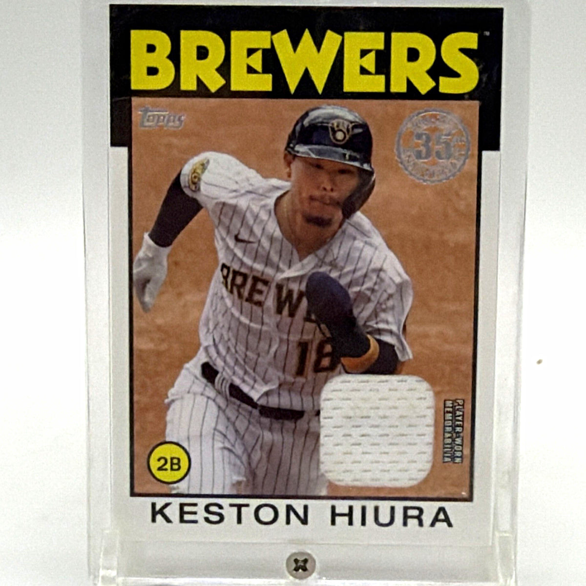 Front of 2021 Topps Keston Hiura #86R-KH 1986 Baseball Relic card featuring Milwaukee Brewers uniform and white memorabilia swatch