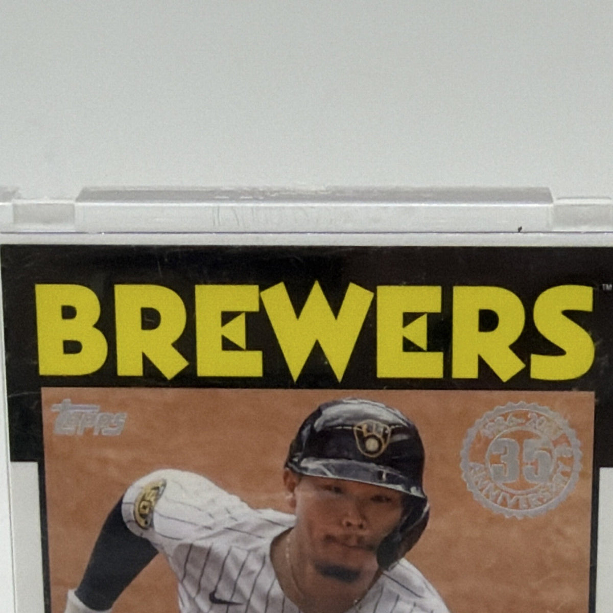 Close-up of yellow Brewers lettering and Keston Hiura on his 2021 Topps relic card