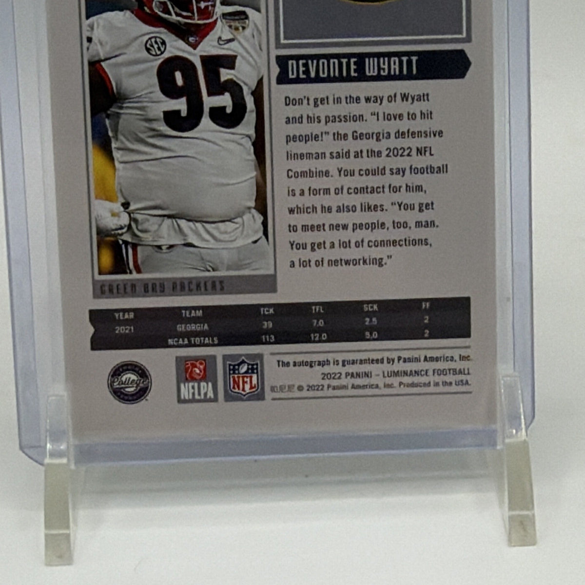 Full reverse view of Devonte Wyatt 2022 Luminance football card in protective holder