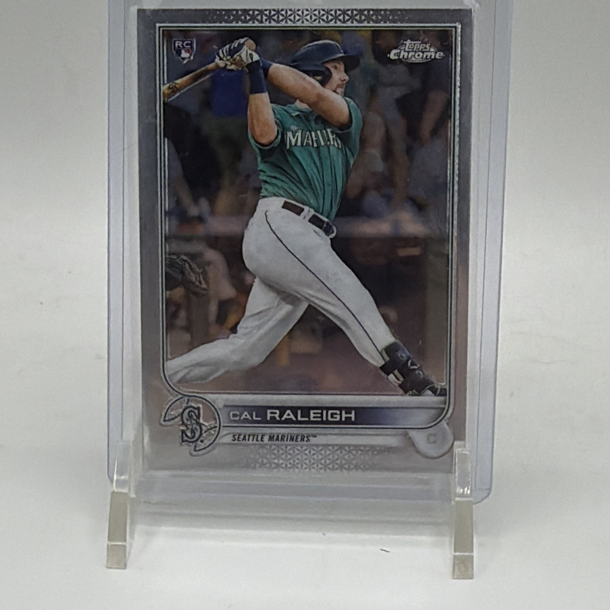 Front of 2022 Topps Chrome Cal Raleigh #149 rookie card featuring the Seattle Mariners catcher batting