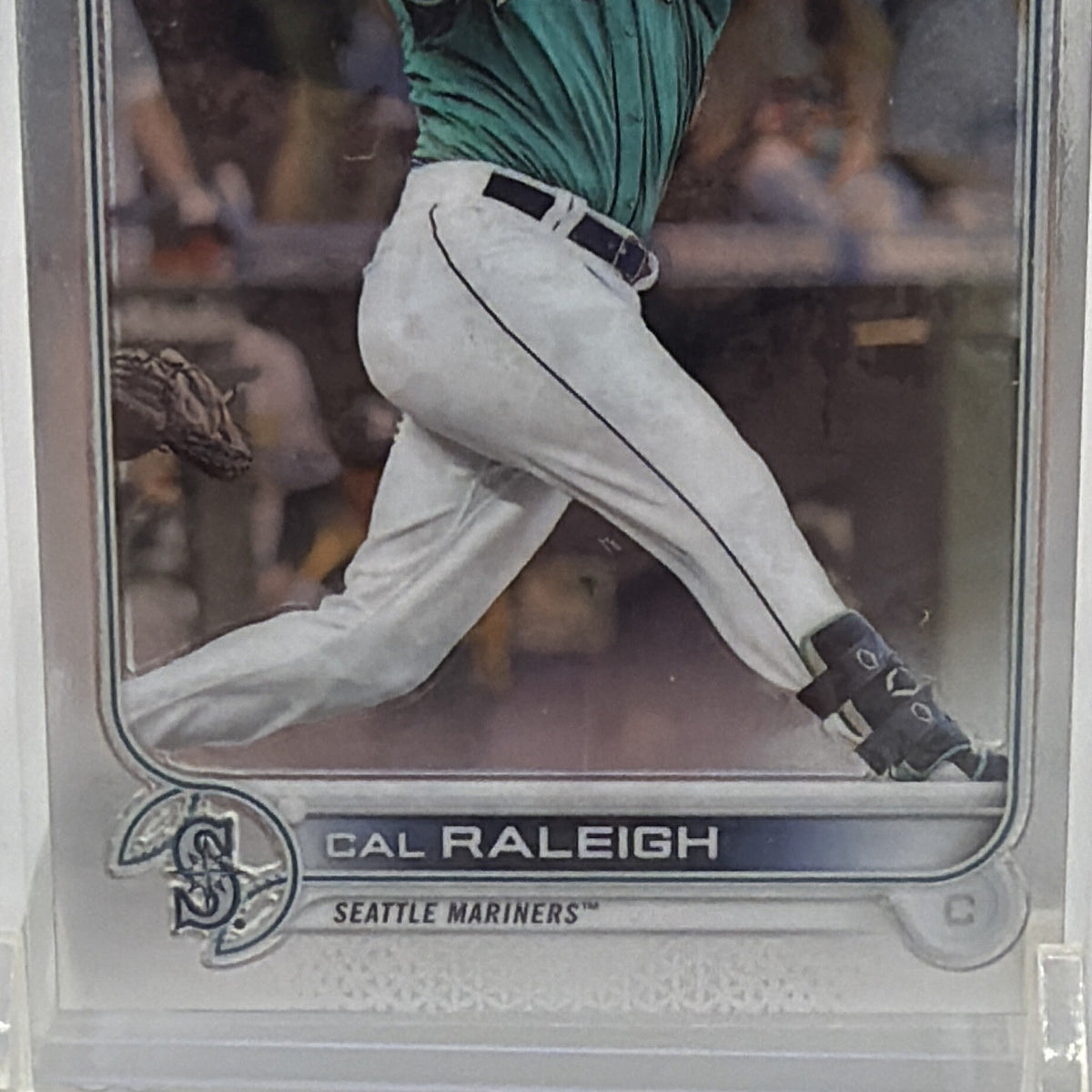 Close-up of lower front of Cal Raleigh #149 rookie card showing his name, Seattle Mariners logo, and rookie designation