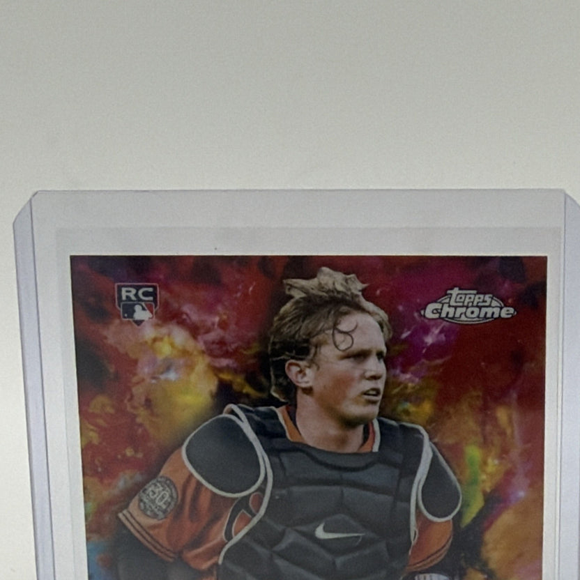 Close-up of Adley Rutschman's portrait, rookie logo, and orange-red Chrome background