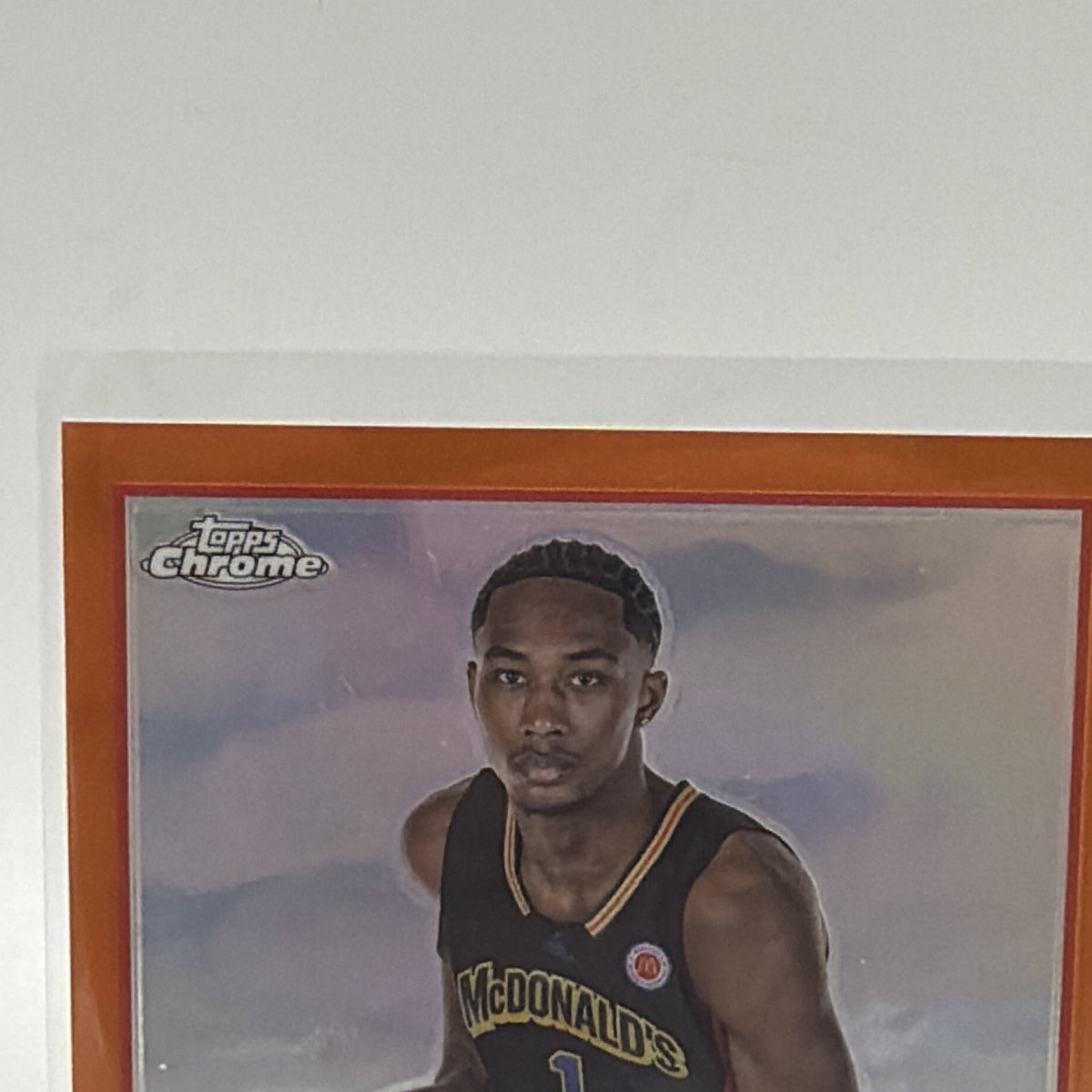 Upper front close-up showing Ron Holland II in McDonald's All American uniform with orange Chrome border