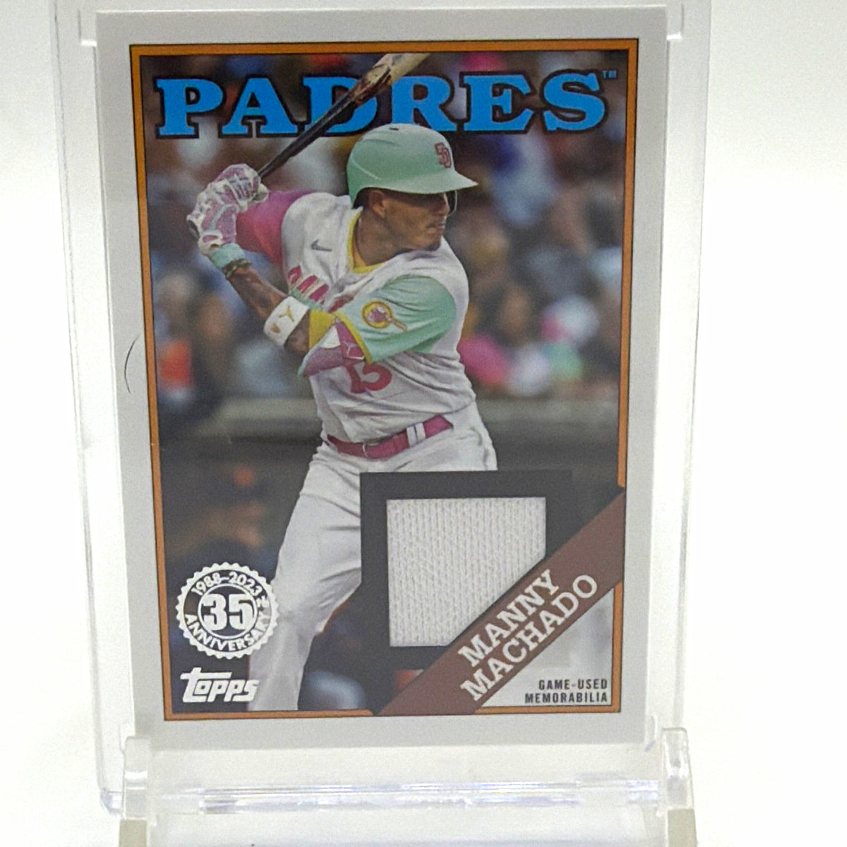 Front of 2023 Topps Series 1 Manny Machado 1988 Baseball Relic #88R-MM with game-used memorabilia