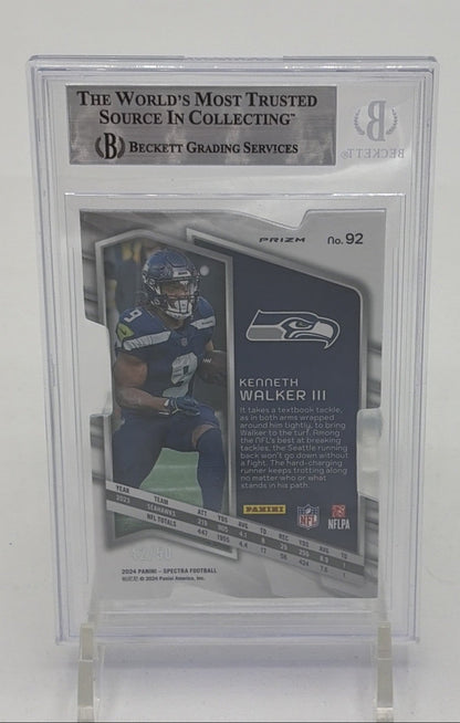 Back of 2024 Panini Spectra Kenneth Walker III Neon Blue Die-Cut card numbered 42 of 50 in BGS 9 holder, showing player statistics, biography, and Seattle Seahawks branding.