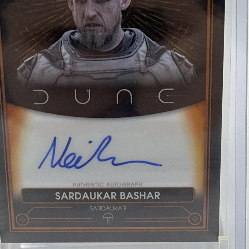 Close-up of blue Neil Bell autograph, Sardaukar Bashar nameplate, and gold-toned card border