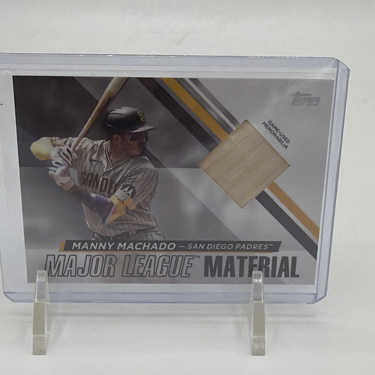 Front of 2024 Topps Series 1 Manny Machado Major League Material #MLM-MM with game-used bat relic