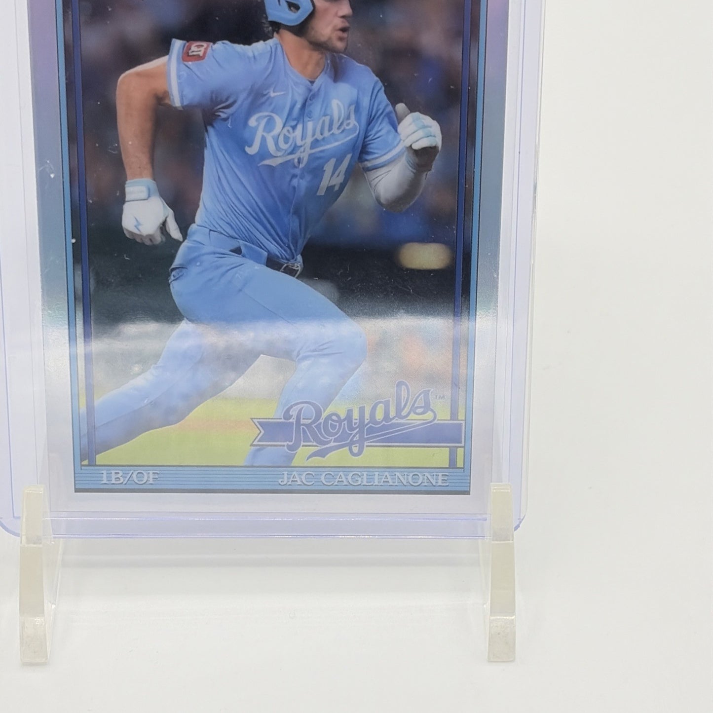 Lower front detail of a 2026 Topps Chrome Jac Caglianone Rookie Card showing the Royals script logo, player name, and chrome refractor finish.