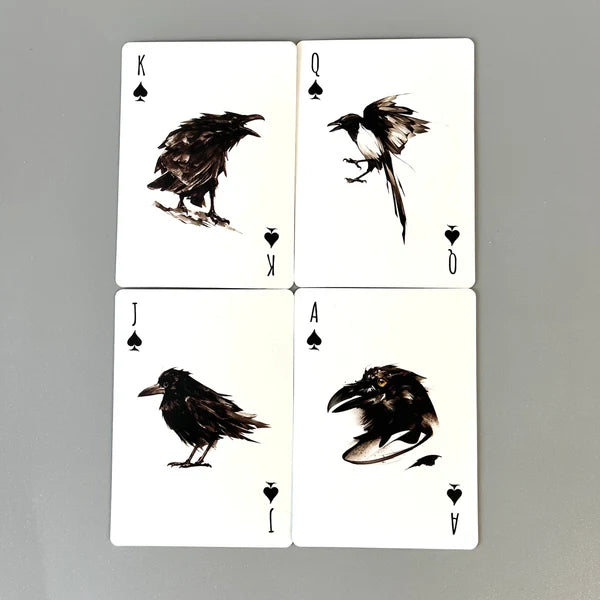 Four illustrated Be Like A Crow playing cards arranged in a square